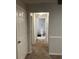 Hallway leading to a well-maintained bathroom featuring neutral tones and clean fixtures at 3417 Westchester Square Blvd # 202, Orlando, FL 32835