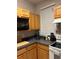 Well-lit kitchen featuring wood cabinets and essential appliances for everyday cooking at 3417 Westchester Square Blvd # 202, Orlando, FL 32835
