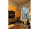 Cozy kitchen featuring wood cabinets, black appliances, and a view of the backyard through the window at 3417 Westchester Square Blvd # 202, Orlando, FL 32835