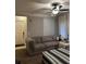 Inviting living room featuring a comfortable gray sectional couch and bright natural light from large windows at 3417 Westchester Square Blvd # 202, Orlando, FL 32835