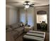 Cozy living room with built-in desk, lots of natural light, and a comfortable gray sectional at 3417 Westchester Square Blvd # 202, Orlando, FL 32835