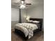 Comfortable main bedroom featuring a ceiling fan, window with curtains, and a cozy bed with blanket at 3417 Westchester Square Blvd # 202, Orlando, FL 32835