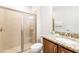 Well-lit bathroom with a glass-enclosed shower, granite countertops, and modern fixtures at 408 Southfield St, Kissimmee, FL 34747