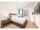 Comfortable bedroom featuring a plush bed, stylish nightstands, and a wall-mounted television at 408 Southfield St, Kissimmee, FL 34747