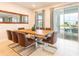 Dining area features seating for eight, stylish decor, and natural light from sliding glass doors at 408 Southfield St, Kissimmee, FL 34747