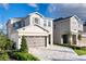 Two-story home features a paved driveway, two-car garage, and neutral exterior paint scheme at 408 Southfield St, Kissimmee, FL 34747