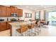 Open kitchen features granite countertops, stainless steel appliances, and a breakfast bar at 408 Southfield St, Kissimmee, FL 34747
