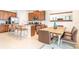Kitchen with granite countertops, stainless steel appliances, island seating and an adjacent dining area at 408 Southfield St, Kissimmee, FL 34747
