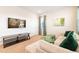 Relaxing living room with sectional sofa, TV, and stylish decor, perfect for downtime and movies at 408 Southfield St, Kissimmee, FL 34747