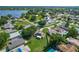 Expansive aerial view of a neighborhood with lush trees and a lake nearby at 439 Lake Daisy Dr, Winter Haven, FL 33884