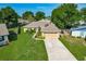Inviting single-story home features a well-maintained lawn and a convenient two-car garage at 439 Lake Daisy Dr, Winter Haven, FL 33884