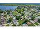 Wide aerial view of a neighborhood featuring houses, pools, trees, and a large lake at 439 Lake Daisy Dr, Winter Haven, FL 33884
