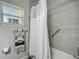Bathroom featuring a shower with a shower curtain and a window with natural light at 439 Lake Daisy Dr, Winter Haven, FL 33884