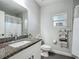 Bathroom vanity featuring granite countertop, decorative mirror and towel rack at 439 Lake Daisy Dr, Winter Haven, FL 33884