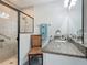 Bathroom featuring a glass shower, granite counter, and a stylish mirror at 439 Lake Daisy Dr, Winter Haven, FL 33884