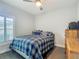 Comfortable bedroom featuring neutral walls and a window with plantation shutters at 439 Lake Daisy Dr, Winter Haven, FL 33884