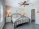 Bright bedroom featuring neutral walls, ceiling fan, and dressers with lamps at 439 Lake Daisy Dr, Winter Haven, FL 33884
