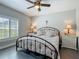 Light filled bedroom with neutral walls, ceiling fan, and side tables with lamps at 439 Lake Daisy Dr, Winter Haven, FL 33884