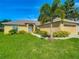 Attractive single-story home boasts a lush green lawn and an attached two-car garage at 439 Lake Daisy Dr, Winter Haven, FL 33884