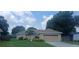 Charming single-story home with a well-manicured lawn and a two-car garage at 439 Lake Daisy Dr, Winter Haven, FL 33884