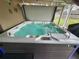 Relaxing hot tub with bubbling water and LED lighting surrounded by enclosed patio at 439 Lake Daisy Dr, Winter Haven, FL 33884