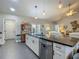 Kitchen island with bar stool seating, granite counters and stainless steel dishwasher at 439 Lake Daisy Dr, Winter Haven, FL 33884