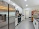 Stainless steel appliances including a refrigerator, oven, and microwave compliment the white cabinetry in the kitchen at 439 Lake Daisy Dr, Winter Haven, FL 33884