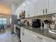 Bright kitchen with white cabinetry, granite countertops, and stainless steel appliances at 439 Lake Daisy Dr, Winter Haven, FL 33884