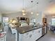 Open concept kitchen with granite countertops, pendant lighting, and stainless steel appliances at 439 Lake Daisy Dr, Winter Haven, FL 33884