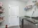 Well-organized laundry room featuring gray, front-loading washer and dryer and wire shelving at 439 Lake Daisy Dr, Winter Haven, FL 33884