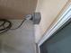Exterior outlet mounted on stucco wall next to window frame and black cord plugged in at 439 Lake Daisy Dr, Winter Haven, FL 33884