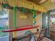 Outdoor tiki bar area featuring a surfboard bar, tropical decor, and comfortable seating at 439 Lake Daisy Dr, Winter Haven, FL 33884