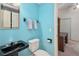 The bathroom features a black sink, toilet, mirror, and towels at 4823 Shoreline Cir, Sanford, FL 32771
