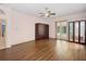 A large bedroom with wood laminate flooring, ceiling fan, and doors to the pool at 4823 Shoreline Cir, Sanford, FL 32771