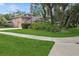 Side view of house with well maintained green lawn and mature shrubbery at 4823 Shoreline Cir, Sanford, FL 32771