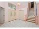 Spacious foyer with tile flooring, a staircase, and a decorative light fixture at 4823 Shoreline Cir, Sanford, FL 32771