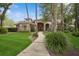 Beautiful home featuring a manicured lawn, elegant brick facade, and inviting walkway to the front entrance at 4823 Shoreline Cir, Sanford, FL 32771