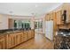 Kitchen with wood cabinets, granite countertops, stainless steel sink, and view to backyard at 4823 Shoreline Cir, Sanford, FL 32771