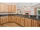 An open-concept kitchen and countertop bar with wood cabinetry and black granite countertops at 4823 Shoreline Cir, Sanford, FL 32771