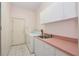 Laundry room with appliances, sink, counter space, and cabinets at 4823 Shoreline Cir, Sanford, FL 32771