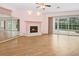 Open concept living room showcasing fireplace, backyard views, and vinyl flooring at 4823 Shoreline Cir, Sanford, FL 32771