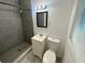 Cozy bathroom features tiled walk-in shower, vanity, and toilet at 49 Orange Park Blvd, Lake Wales, FL 33898
