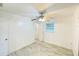 Bright bedroom with tile flooring, ceiling fan and natural light from two windows at 49 Orange Park Blvd, Lake Wales, FL 33898