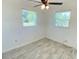 This bedroom features tiled flooring, ceiling fan and windows with natural light at 49 Orange Park Blvd, Lake Wales, FL 33898