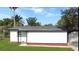Side view of a white home with a dark roof and a well-maintained lawn at 49 Orange Park Blvd, Lake Wales, FL 33898