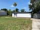 Exterior of home featuring a well-maintained lawn, palm tree, and driveway at 49 Orange Park Blvd, Lake Wales, FL 33898
