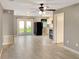 Open living space with tile floors, ceiling fan and access to the kitchen at 49 Orange Park Blvd, Lake Wales, FL 33898