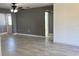 Open living room features neutral paint, tiled flooring and access to other rooms at 49 Orange Park Blvd, Lake Wales, FL 33898