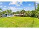 Huge backyard featuring green grass and a small house with a deck at 536 W King St, Orlando, FL 32804