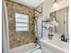 Bathroom featuring neutral tile, vanity sink, and shower and bathtub combo at 536 W King St, Orlando, FL 32804